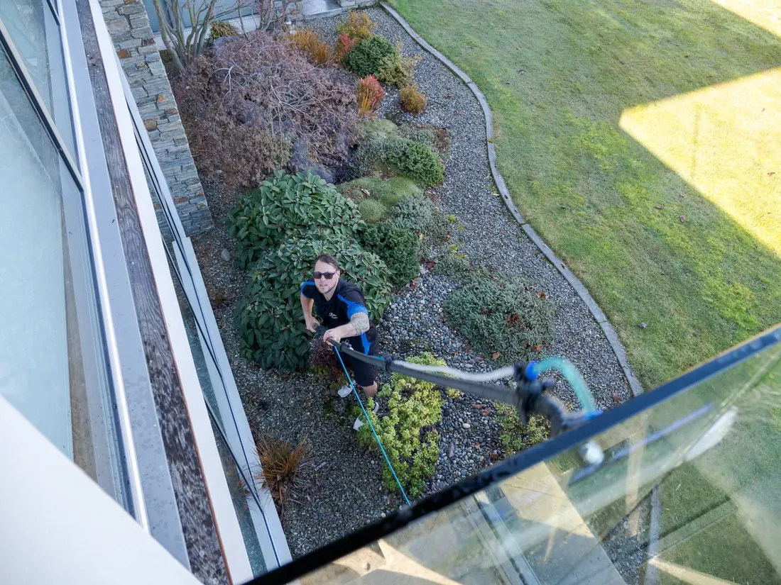 Clean glass balustrade looking down over a Wanaka garden