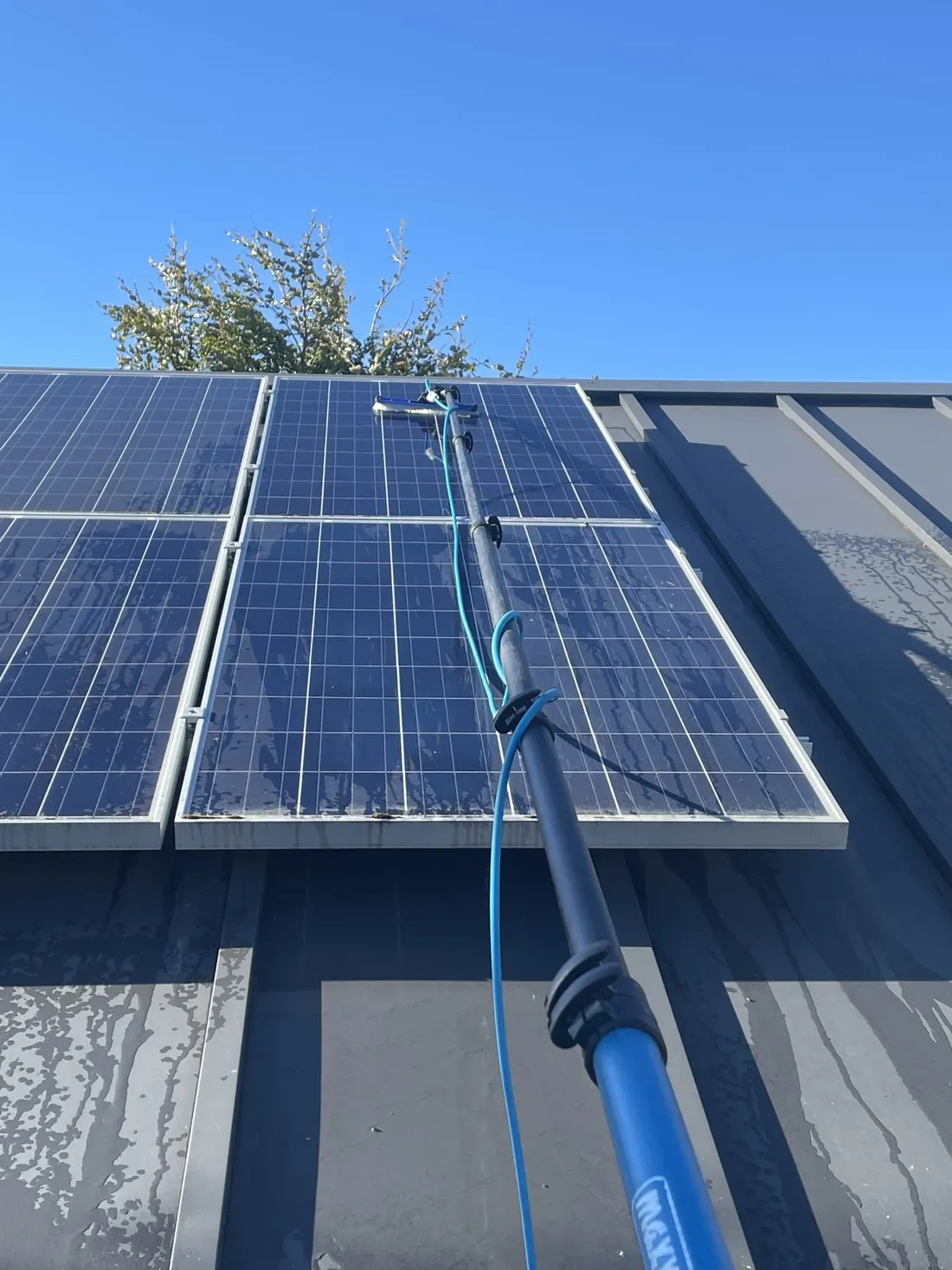 Solar panels cleaned with a water-fed pole in Central Otago