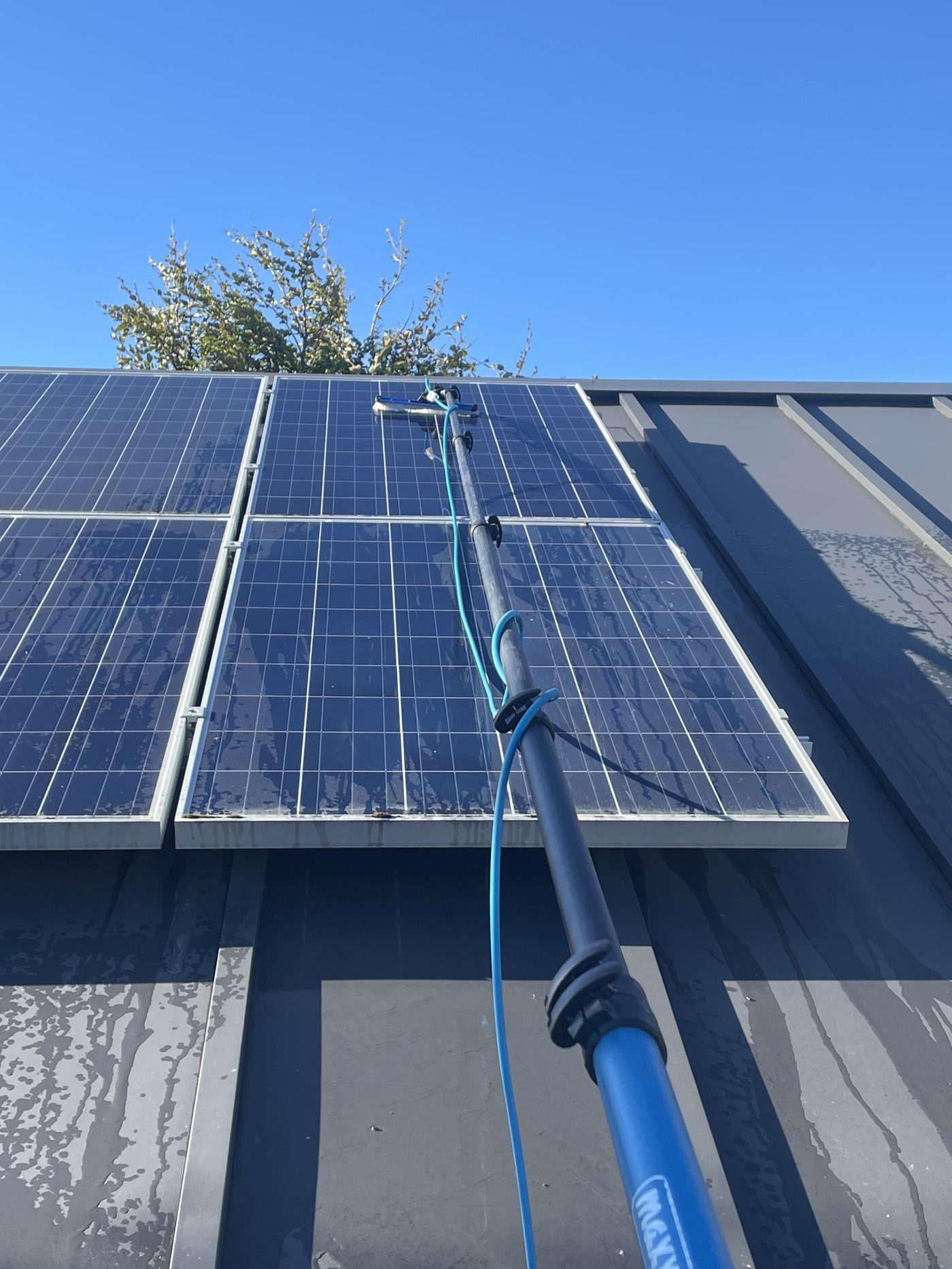 Solar panels cleaned with a water-fed pole in Central Otago